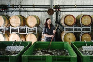 Stephanie Helm is plunging fermenting wine in the barrel room